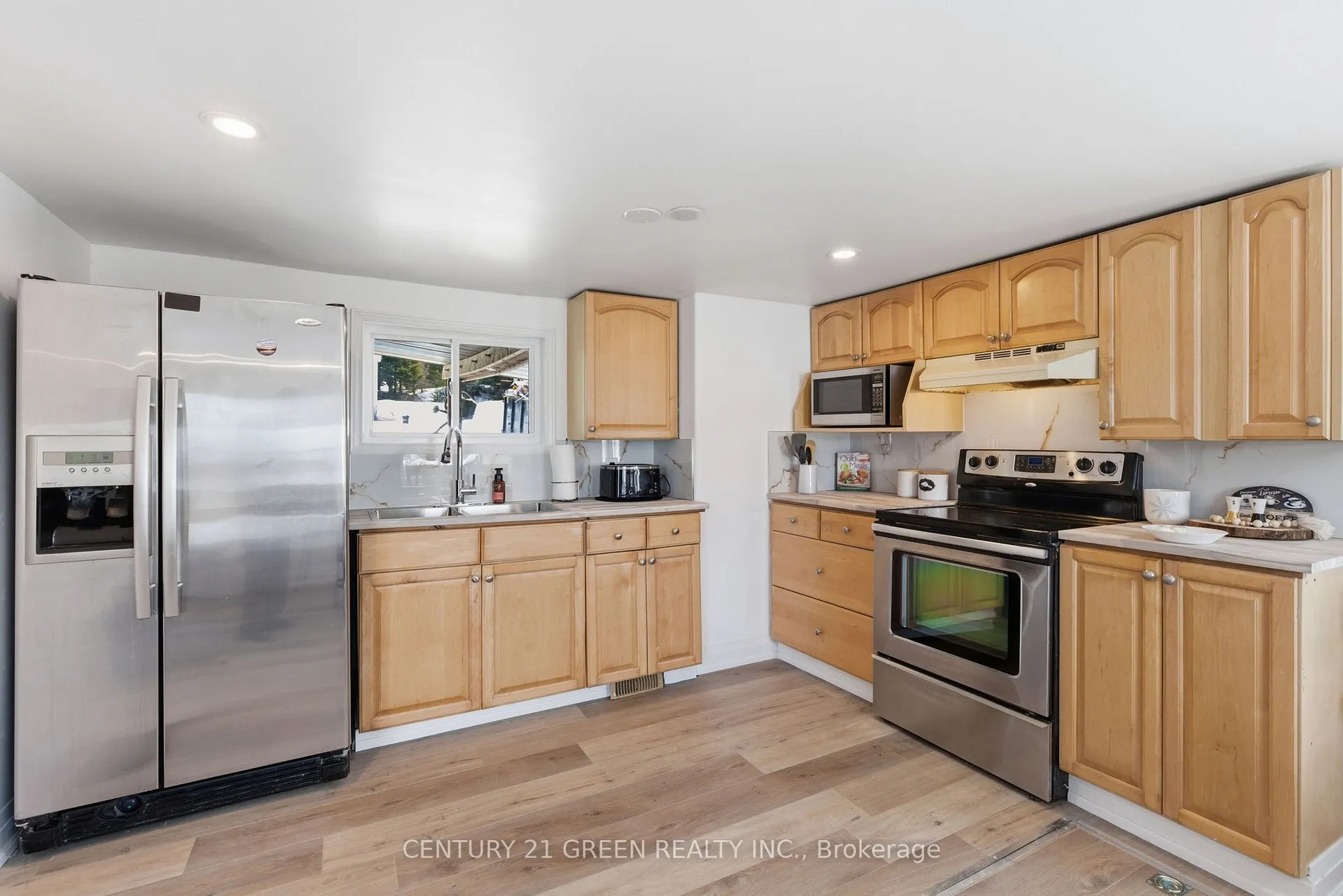 135 Village Street, Hastings Highlands — kitchen with wood cabinetry, stainless refrigerator and stove