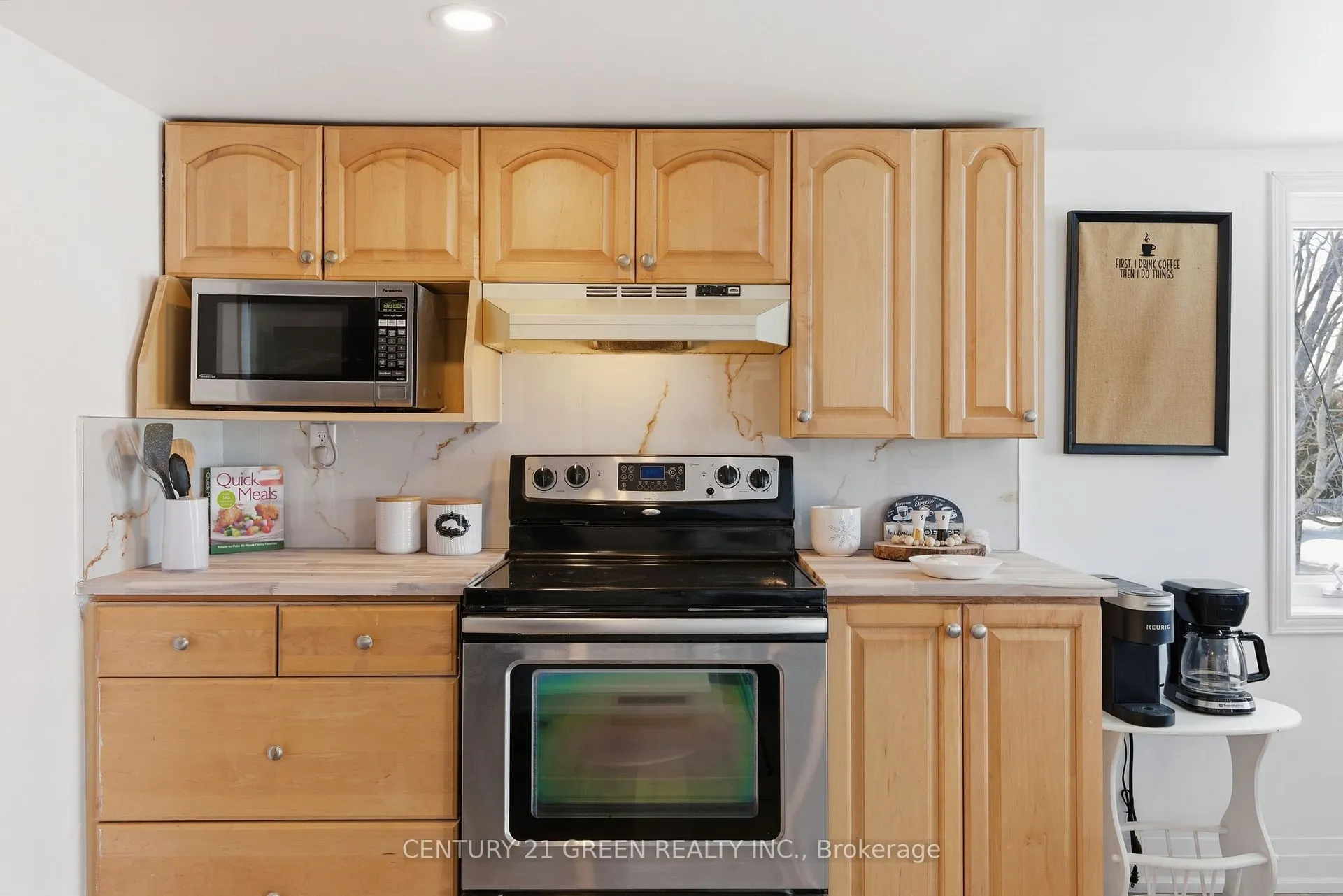 135 Village Street, Hastings Highlands — close kitchen view with stove, microwave and wood cabinetry