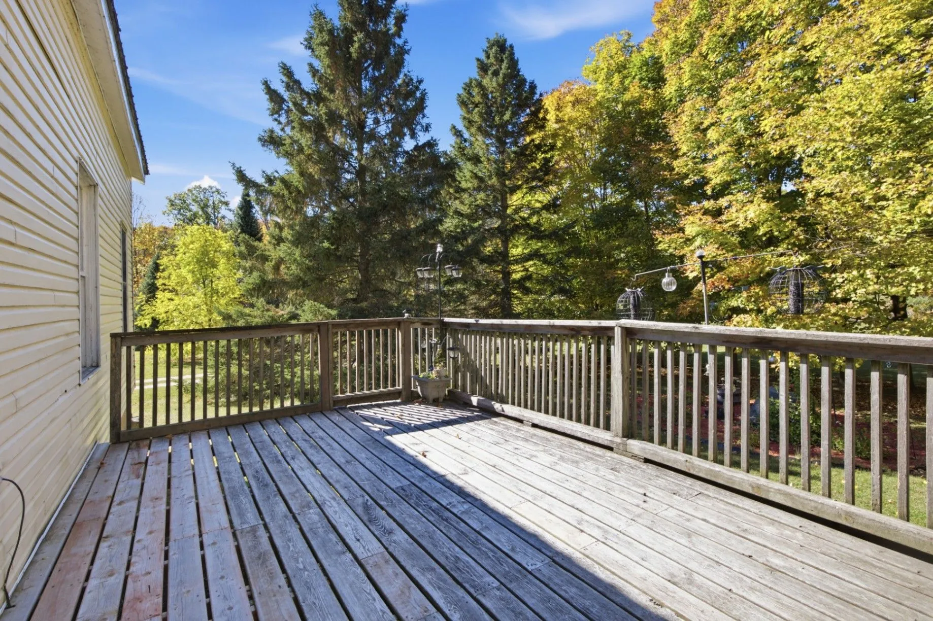 3192 Matawatchan Rd, Greater Madawaska — wraparound wooden deck overlooking mature hardwood forest