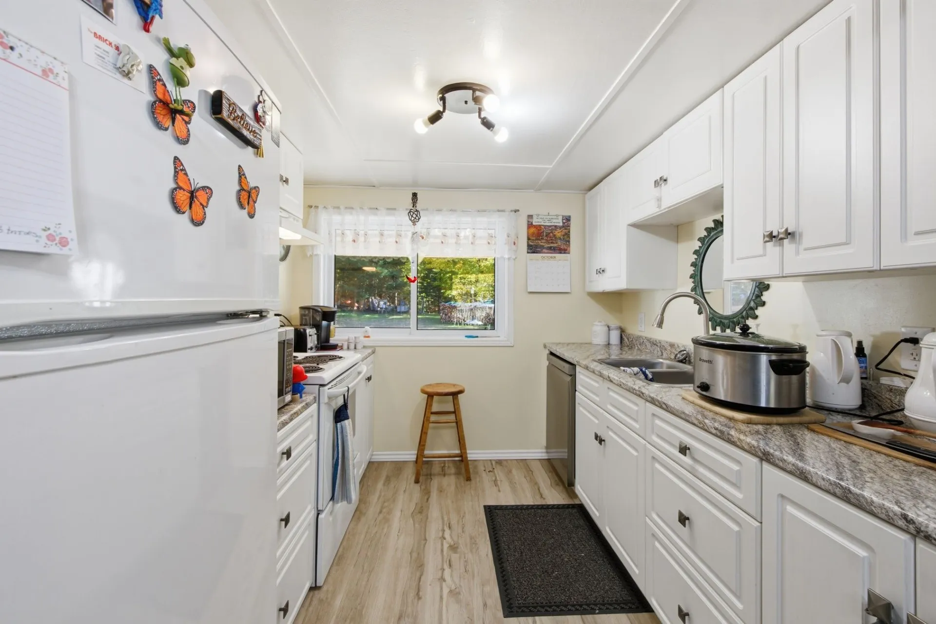 3192 Matawatchan Rd, Greater Madawaska — updated kitchen with white cabinets, granite-look counters and vinyl plank flooring
